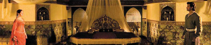 Man and woman facing eaching other at the bottom of the bed